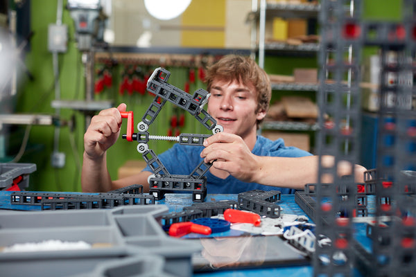 A high school student builds a motorcycle lift with a Sphero Blueprint Build Kit.