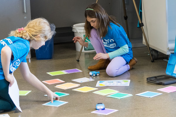 Two girls in a STEM class doing an activity with Sphero indi robots.