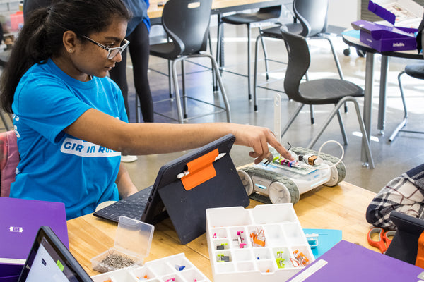 A girl learning STEM programming an RVR+ robot.
