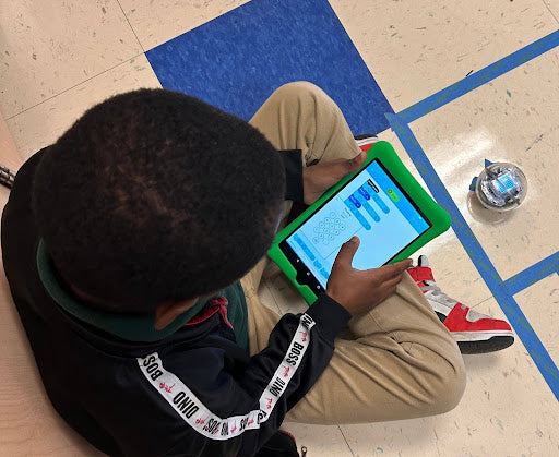 A student codes a Sphero BOLT robot with an ipad