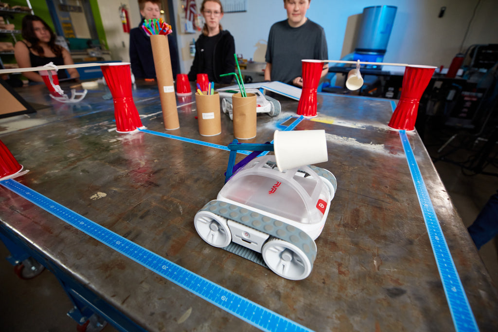 Students watch as a Sphero RVR+ completes the Apple Picking activity.