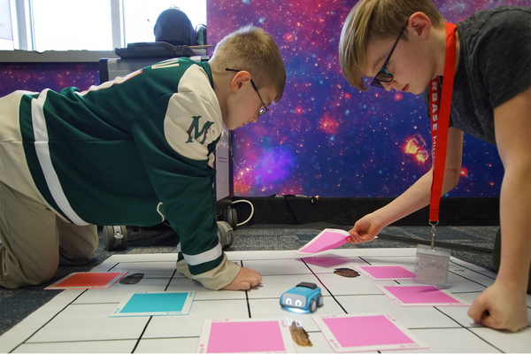 Two students create a path for indi.