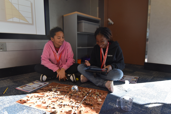 Two students code BOLT through a Mars landscape.
