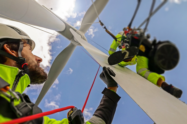 Two wind turbine service technicians at work.