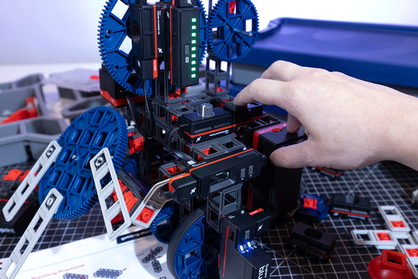 A hand working on a Blueprint Engineering build.