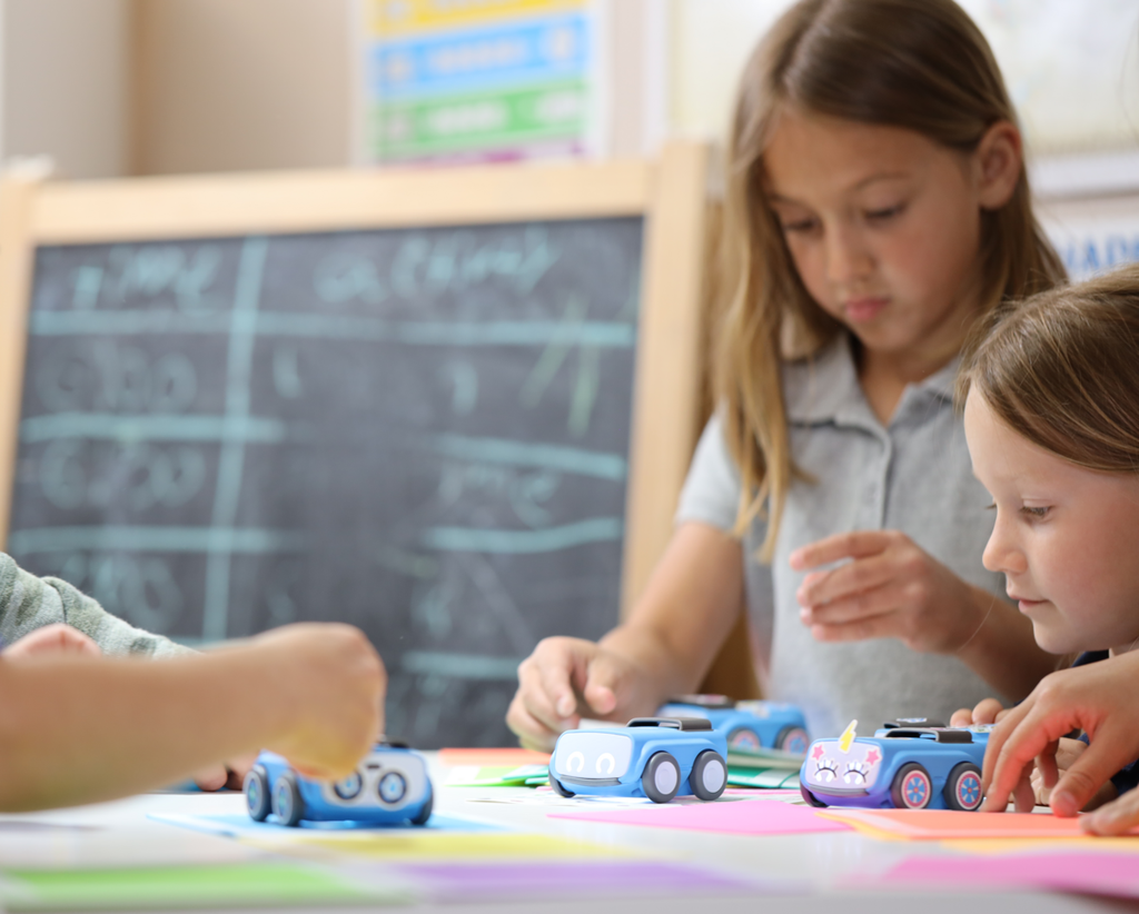 Elementary students work on a math activity with Sphero indi.