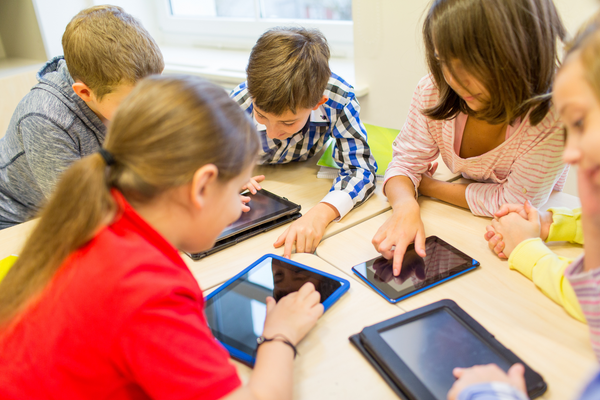 Students use tablets to navigate apps.