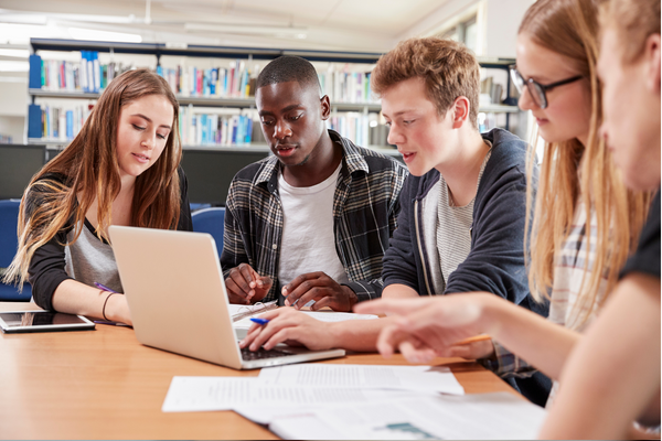 Students work together on a laptop.