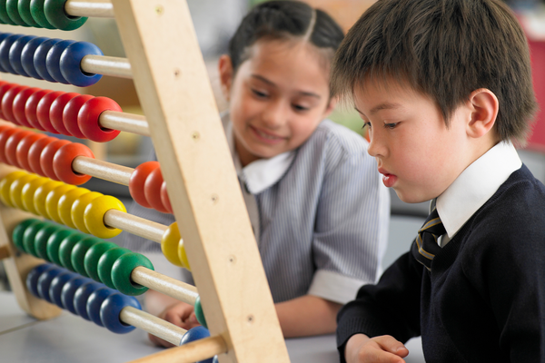 Two students using an abaci.