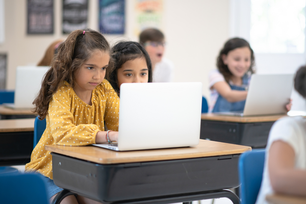 Young students working on laptops.